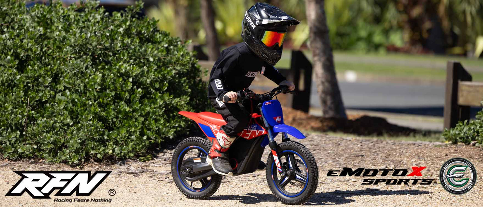 Child riding a red and RFN WARRIOR blue kids electric  bike | eMotoX Sports
