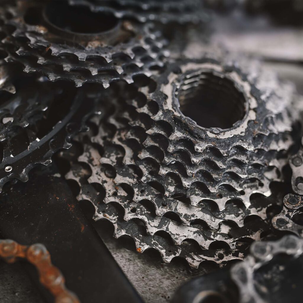 Close-up of a bicycle cassette and drivetrain after a deep clean, showing detailed bike gears free of dirt and grease - eMotoX Sports