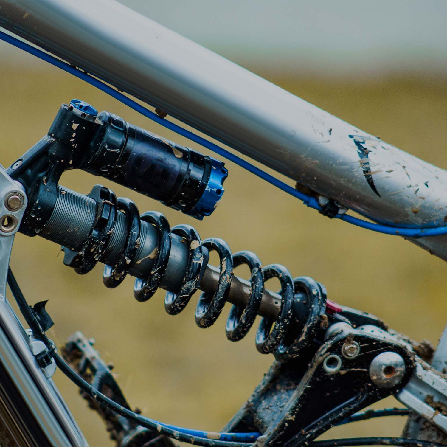 Close-up of mountain bike rear suspension shock absorber and linkage system - eMotoX Sports